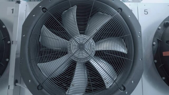 Large, powerful, industrial gray color fan at industrial equipment show, does not rotate. Shot in motion. Closeup
