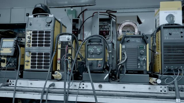 A number of industrial welding machines of different power and mobility at the exhibition of welding equipment. Shot in motion