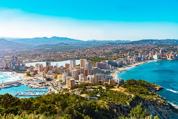 Fototapeta na wymiar Panorama of Calpe, province of Alicante, Costa Blanca in summer. Harbor with sea ships, yachts. View from the rock Penon de Ifach. Landscape outside the city. Travel, hiking, vacation at sea concept.