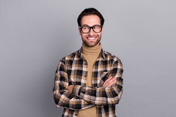 Photo of dreamy clever guy dressed checkered shirt glasses arms folded empty space isolated grey color background
