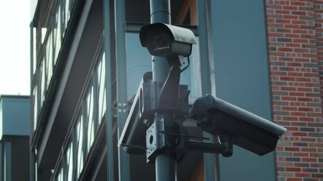 Polygonal closed-loop camera of a video surveillance system , a street security surveillance camera installed on the street against a residential building