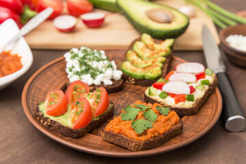 Assortment vegan, vegetarian sandwiches. Healthy homemade sandwich with different vegetables and greens on plate close up