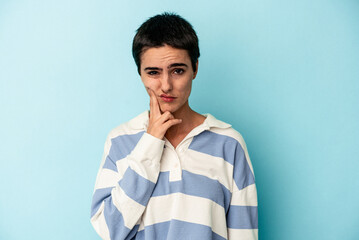 Young caucasian woman isolated on blue background having a strong teeth pain, molar ache.