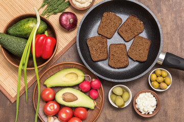 Ingredients for cooking vegan vegetarian sandwiches with different vegetables on kitchen. Healthy diet food concept