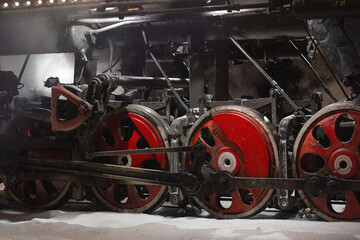 vintage retro train arrives at the train station, metal wheels on rails