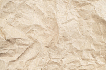 Obraz premium Recycled brown creased paper background from a paper packing. Crumpled brown paper texture concept