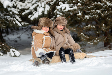 Fototapeta premium Two cute kids in winter Russian folk clothes like in a fairy tale