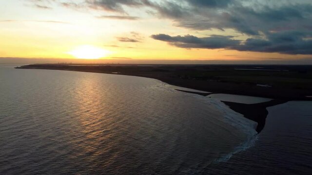 4k drone footage of the sun setting over the coast at Shingle Street in Suffolk, UK