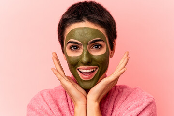 Young caucasian woman wearing a face mask isolated on pink background