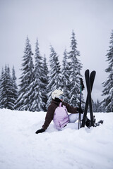 young woman athlete posing on skis on a mountain slope. professional sportsman is skiing. winter sport