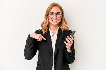 Young business caucasian woman holding mobile phone isolated on white background person pointing by hand to a shirt copy space, proud and confident