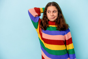 Little caucasian girl isolated on blue background touching back of head, thinking and making a...
