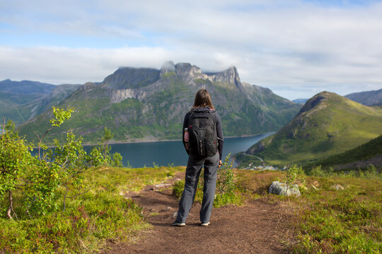 Happy family, standing on a rock and looking over Segla mountain on Senja island, North Norway. Amazing beautiful landscape and splendid nature