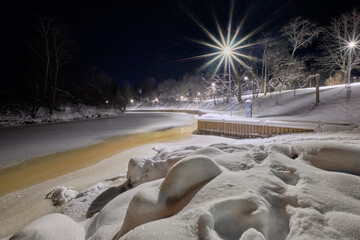 river docks in winter with snow in the evening