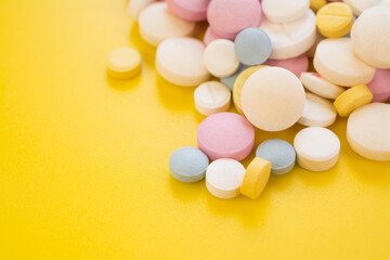 Fototapeta na wymiar Colored pills for toothache or minstrual pain