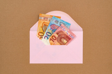 A pink envelope full of money