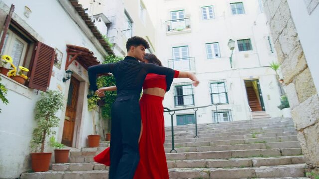 Beautiful Couple Dancing a Latin Dance on the Quiet Street of an Old Town in a City. Sensual Dance by Two Professional Dancers on a Sunny Day Outside in Ancient Culturally Rich Tourist Location.