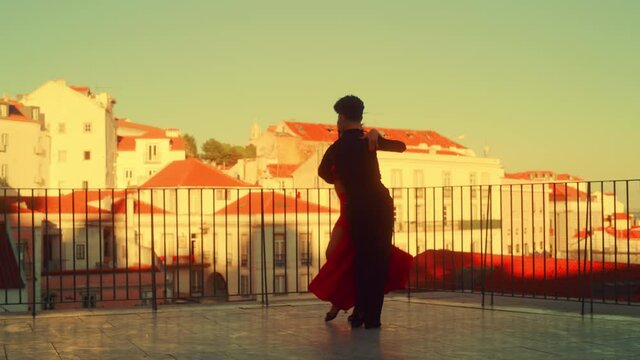 Beautiful Couple Dancing a Latin Dance Outside the City with Old Town in the Background. Sensual Dance by Two Professional Dancers on a Sunset in Ancient Culturally Rich Tourist Location.