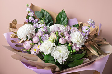Beautiful bouquet with chrysanthemums, roses, carnations on color background. Decorative floral composition. copy space