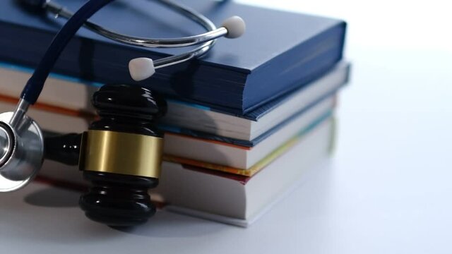 Gavel and stethoscope. medical jurisprudence. legal definition of medical malpractice. attorney. common errors doctors, nurses and hospitals make. Close-up shooting stock footage. slow motion