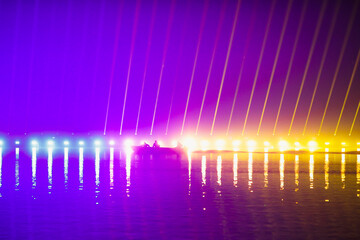 Speedboat in front of a laser show over the lake during New Years celebrations in the Alexandru...