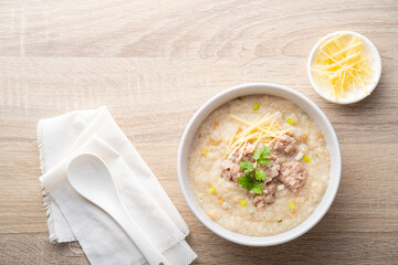 Close up Rice porridge ,congee with minced pork and ginger in white bowl.Top view