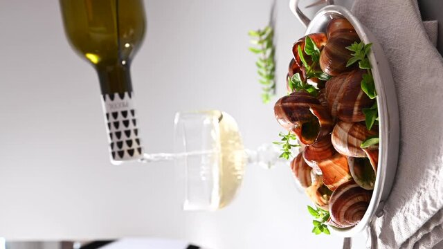 Grilled snails , cooking barbecue seafood with pesto sauce. French cuisine. Vertical video, ideal for social media and smartphones. 4 k