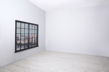 Parquet floor and wooden window in light empty room