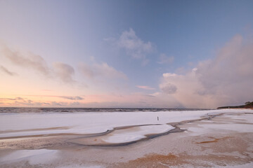 sunset in winter small river frozen snow in the beach