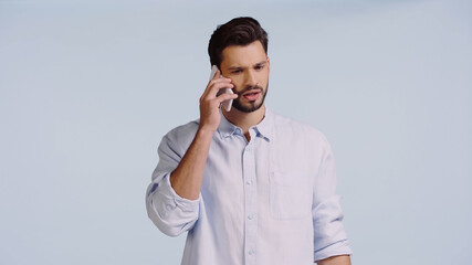 young man talking on cellphone isolated on blue