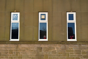 Three Tall Windows in Stone Wall of Building