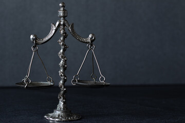 Old-fashioned balance scales in vintage, retro style isolated on dark background. Copy space. Symbol of justice, law, and legal court. Still life. A closeup.