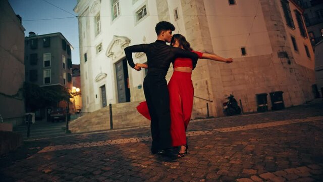 Beautiful Couple Dancing a Latin Dance on the Quiet Street of an Old Town in a City. Sensual Dance by Two Professional Dancers in the Evening in Ancient Culturally Rich Tourist Location.