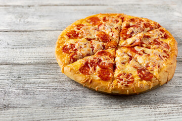 Tasty hot homemade pepperoni pizza. Traditional classic pizza with salami and cheese. With copy space for text.