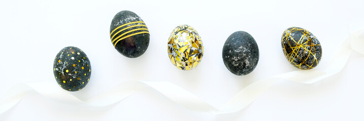 Black easter eggs with gold pattern on white