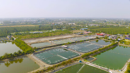 Aerial view of natural sea salt ponds, lake or sea. Farm field outdoor in traditional industry in Thailand. Asia culture. Agriculture irrigation. River reflection.