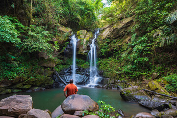Asian traveler with beautiful landscape view of sapan waterfall at Sapan waterfall nan Thailand.Sapan is Small and tranquil Village in the mountain.