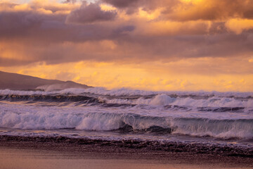 Azores islands, beach with amazing waves and colors, sunset.
