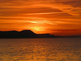 beautiful orange sky over the cliffs and sea at sunrise	
