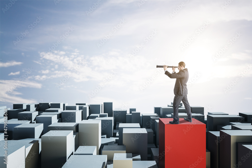 Poster Attractive businessman with telescope standing on abstract blocks and looking into the distance on bright sky background with mock up place for your advertisement. Success and future concept.