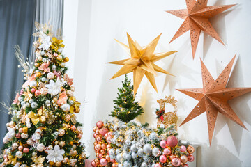 New Year's or Christmas interior: Christmas tree and paper stars with garlands