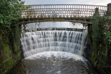 Obraz premium The Weir in Ripley Beck at Ripley Castle North Yorkshire England, United Kingdom