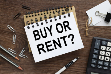 Buy or Rent. text on open notebook on wood background
