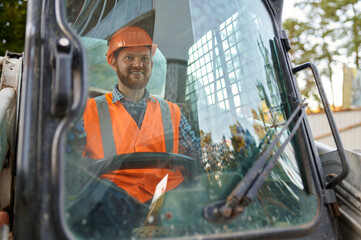 Construction worker in vehicle cab closeup shot