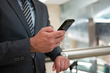 Commuter looking at his mobile phone