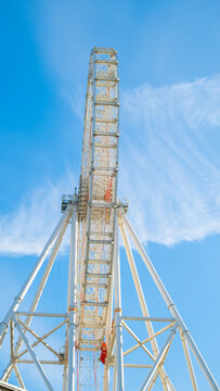 A Big Ferris Wheel Over Blue Sky In The Summer. Front View