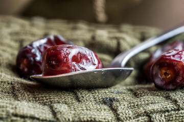 Date Fruit and spoon. Macro photo.