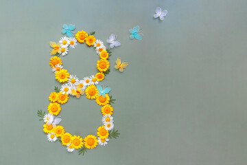 Postcard for March 8. Flowers chamomiles in shape of number eight and butterflies on green background. International Women's Day.