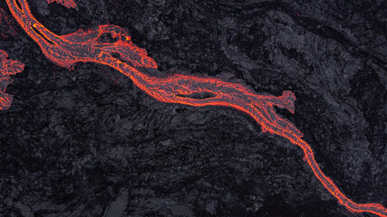 hot lava running on solidified black lava	
