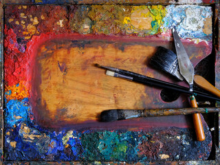 artist's palette with oil paints and brushes